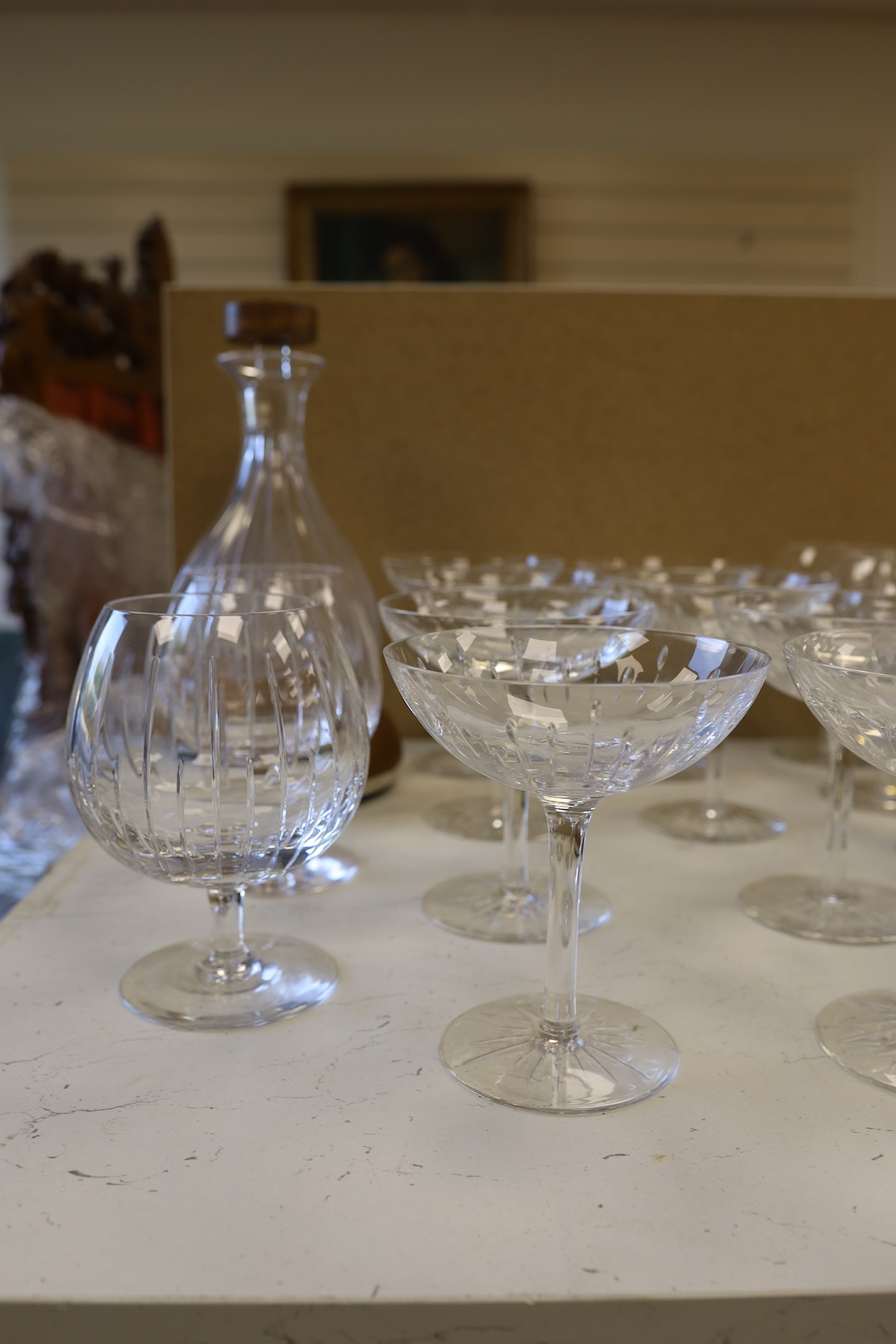 A Linley Glyndebourne pattern cut glass decanter with a silver mounted stopper, on a weighted wooden coaster stand, and a matching set of ten goblets, and eight champagne coupes, largest 30cm high. Condition - all in ver